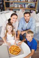 High angle portrait of family with pizza