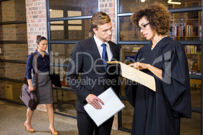 Lawyer looking at documents and interacting with businessman