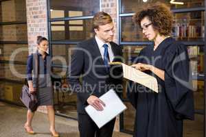 Lawyer looking at documents and interacting with businessman