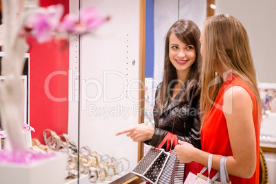 Two beautiful women looking at a display in shop