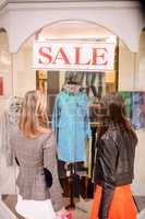 Rear view of two women window shopping