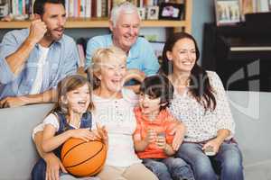 Smiling family watching basketball match