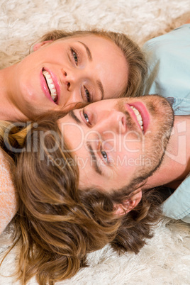 Cute couple resting on the carpet