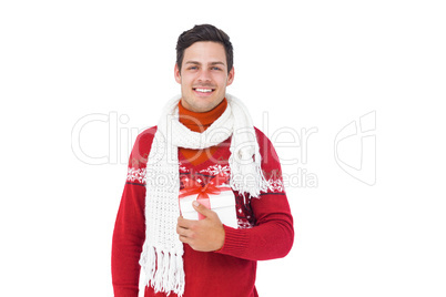 Handsome man with winter clothes holding gift box