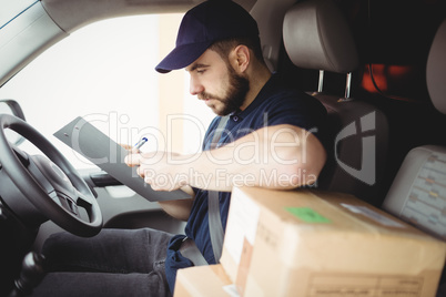 Delivery man sitting in his van