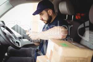 Delivery man sitting in his van