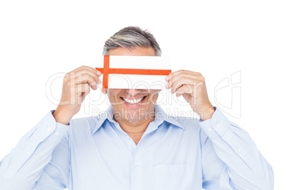 Handsome man covering eyes with gift