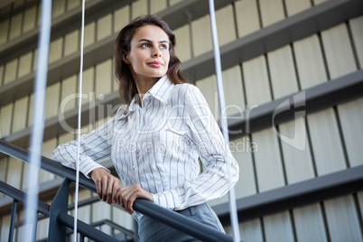 Businesswoman standing near a railing