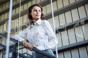 Businesswoman standing near a railing