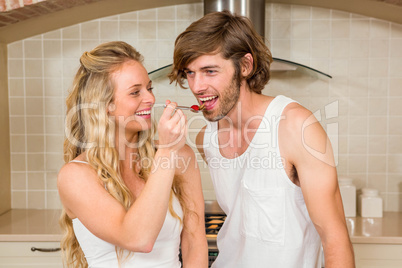 Pretty woman feeding her boyfriend
