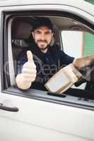 Delivery man sitting in his van