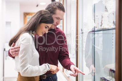 Happy couple shopping in jeweler shop