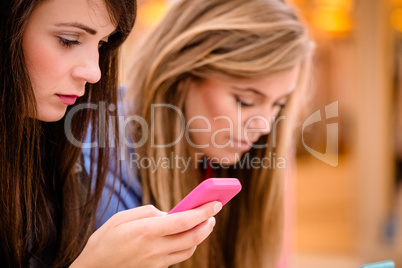 Two beautiful women using their phone Two beautiful women using their phone
