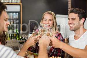 Friends toasting with glasses of white wine