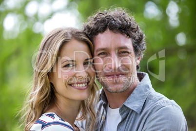 Smiling couple embracing head to head