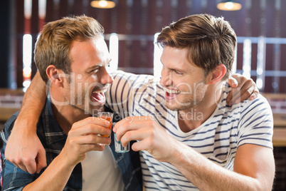 Men toasting with shots
