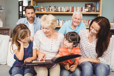 Smiling family with grandparents with photo album