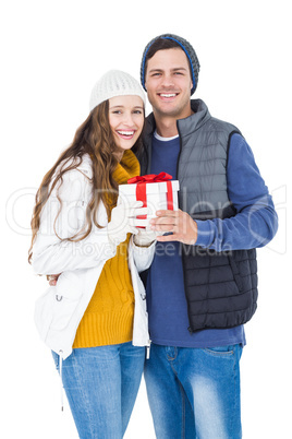 Happy couple holding gift box together