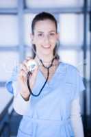 Portrait of female doctor showing stethoscope