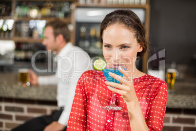 Attractive woman drinking cocktail