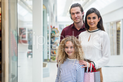 Portrait of happy family in shopping mall