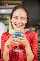 Smiling woman holding cocktail