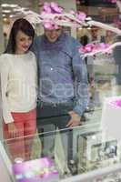 Couple looking at display of wrist watches