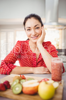 Portrait of happy woman with fruit juice