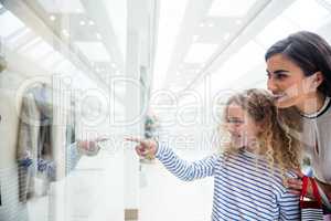 Happy mother and daughter in shopping mall