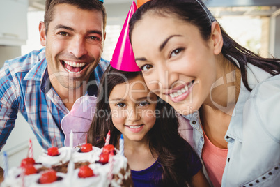 Portrait of cheerful family celebrating birthday at home