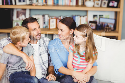 Close-up of family discussing on sofa