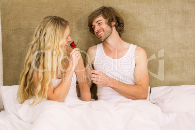 Handsome man offering a rose to his girlfriend