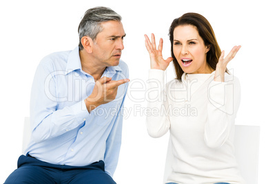 Couple arguing while sitting