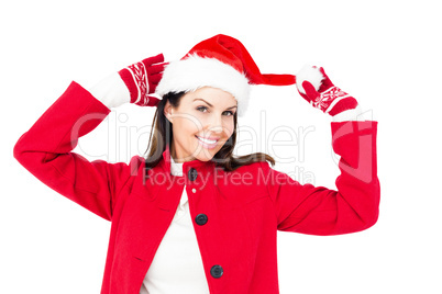 Beautiful brunette holding her santa hat