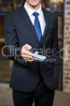 Businessman showing a credit card