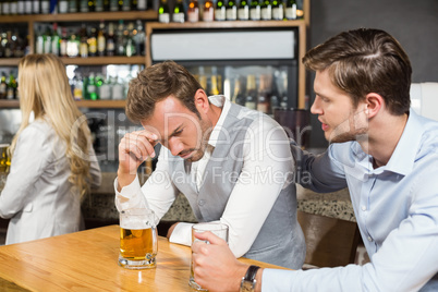 Tired man holding head in hand