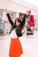 Portrait of excited woman holding shopping bags