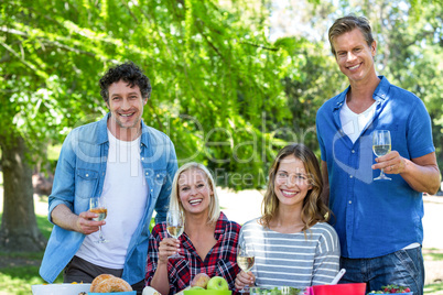 Friends having a picnic with wine