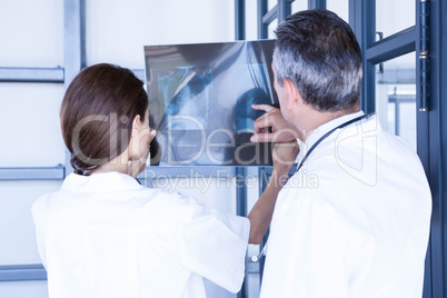 Doctors examining a x report