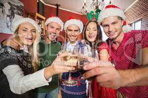Friends wearing Christmas hats toasting