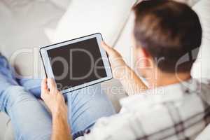 Rear view of man using digital tablet