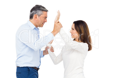 Violent man grabbing wifes wrists