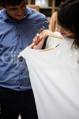 Couple selecting a dress while shopping for clothes