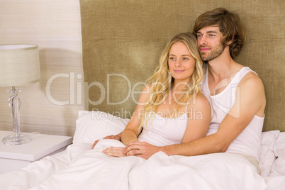 Cute couple cuddling in bed