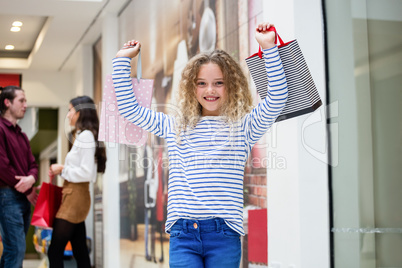 Happy girl holding shopping bags