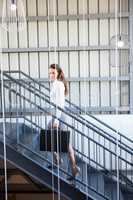 Businesswoman climbing staircase in office