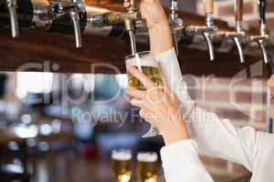 Barmaid pouring beer