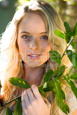 Beautiful blonde posing with branch