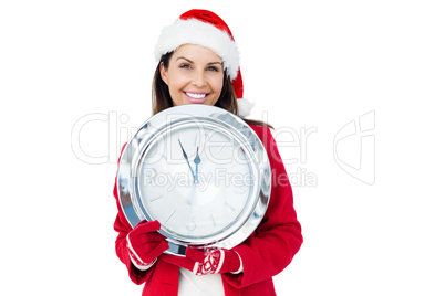 Beautiful brunette with santa hat holding a clock