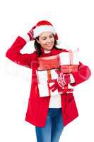 Beautiful brunette with santa hat holding christmas gifts